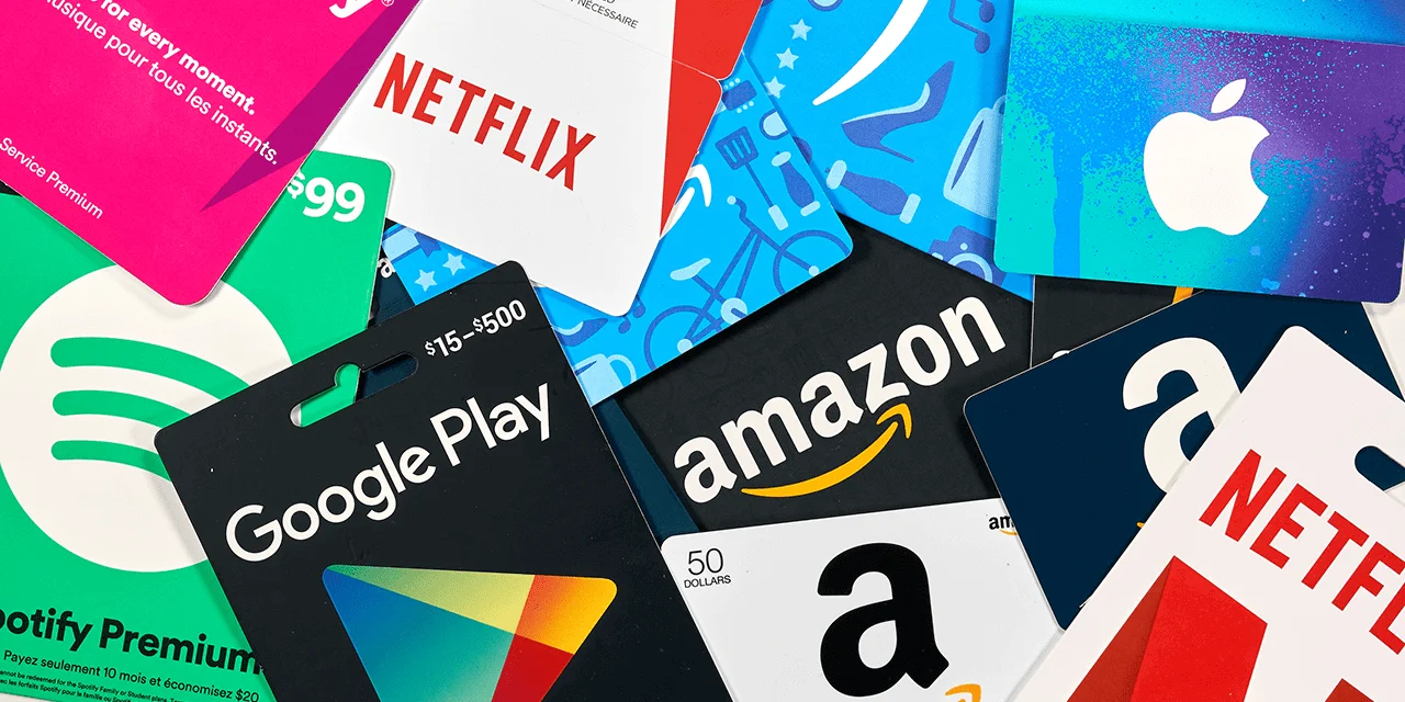 Collection of gift cards including Netflix, Google Play, Amazon, Spotify, and Apple